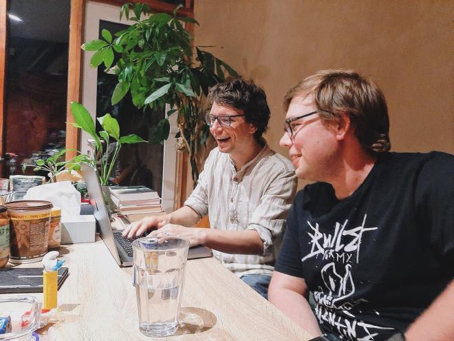 Two people behind a computer